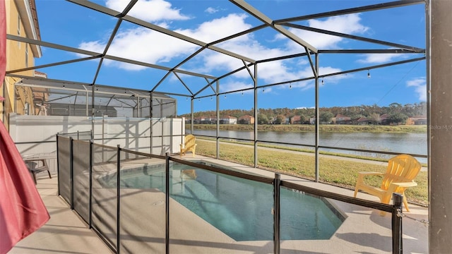 view of swimming pool with a yard, a patio, a water view, and a lanai