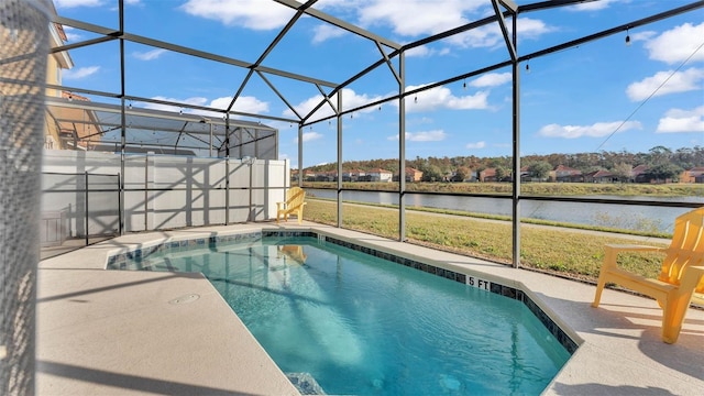 pool with a yard, a water view, a lanai, and a patio area