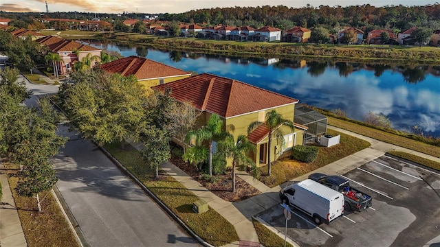 birds eye view of property with a water view and a residential view