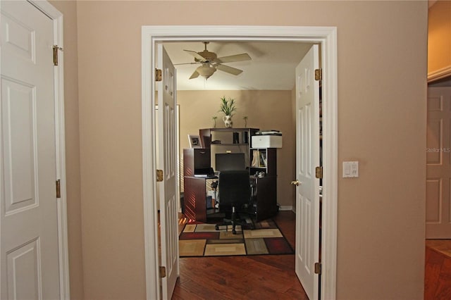 interior space featuring ceiling fan and dark wood-type flooring