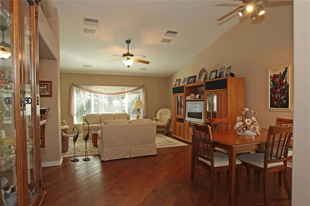 dining room featuring ceiling fan, dark wood-type flooring, and lofted ceiling