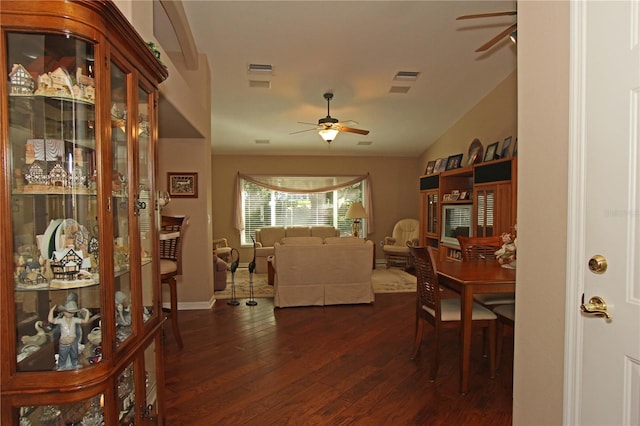 dining space with dark hardwood / wood-style floors, vaulted ceiling, and ceiling fan