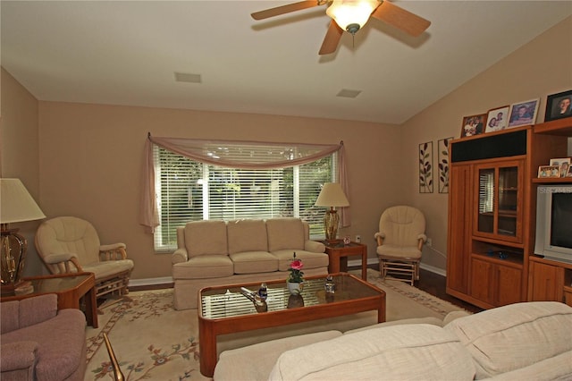 living room featuring ceiling fan and vaulted ceiling