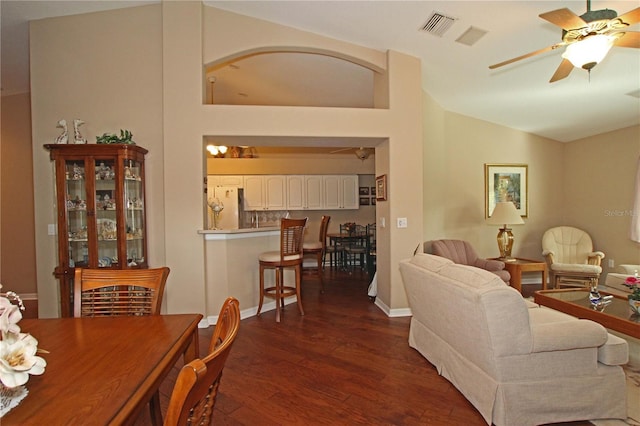 living room with vaulted ceiling, ceiling fan, and dark hardwood / wood-style floors