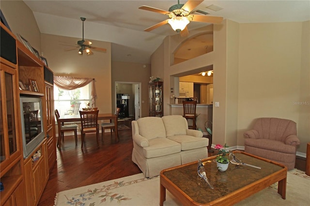 living room with ceiling fan, high vaulted ceiling, and dark hardwood / wood-style floors