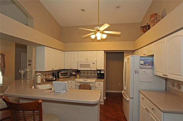 kitchen featuring decorative backsplash, white appliances, high vaulted ceiling, and sink