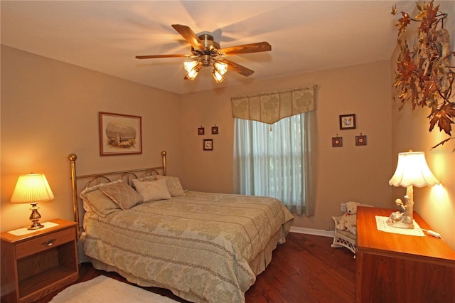 bedroom with dark hardwood / wood-style flooring and ceiling fan