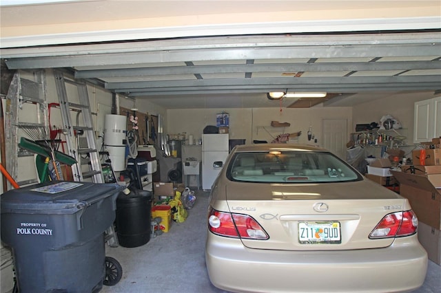 garage featuring white fridge and a garage door opener