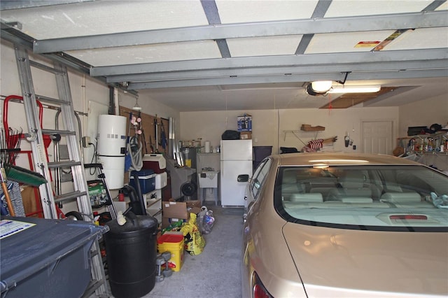 garage with white fridge and a garage door opener