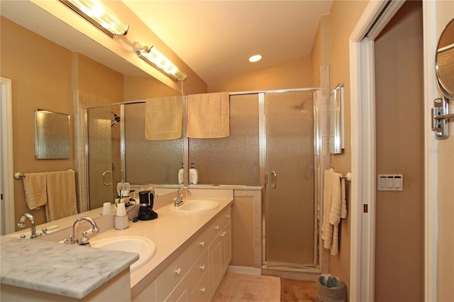 bathroom featuring tile patterned floors, a shower with door, vanity, and vaulted ceiling