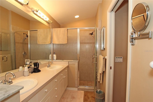 bathroom with tile patterned floors, vanity, vaulted ceiling, and walk in shower