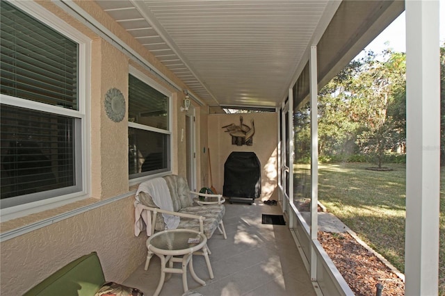 view of patio with area for grilling and a porch