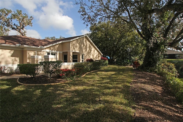 view of home's exterior with a lawn