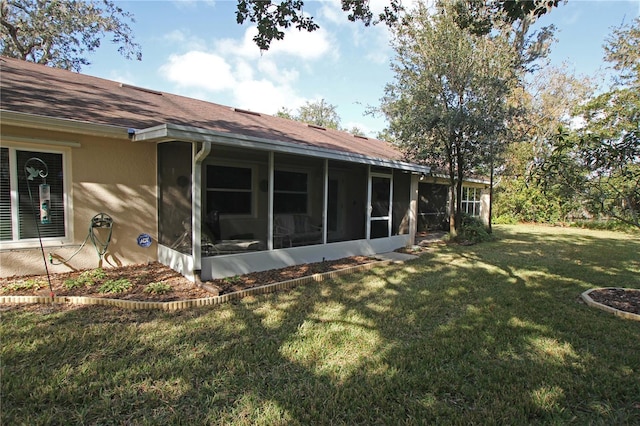 exterior space featuring a lawn and a sunroom