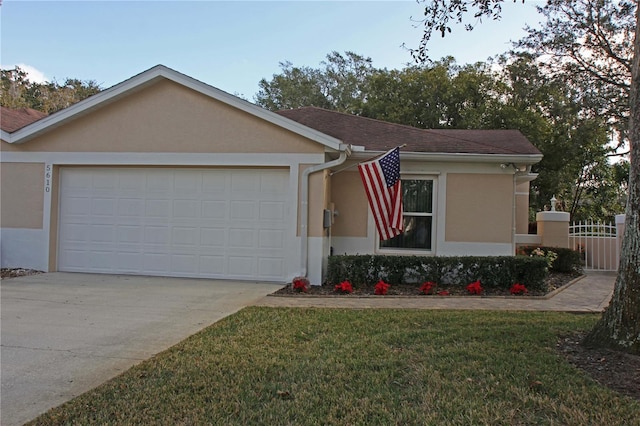 ranch-style home featuring a front yard and a garage