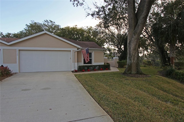 ranch-style house with a garage and a lawn