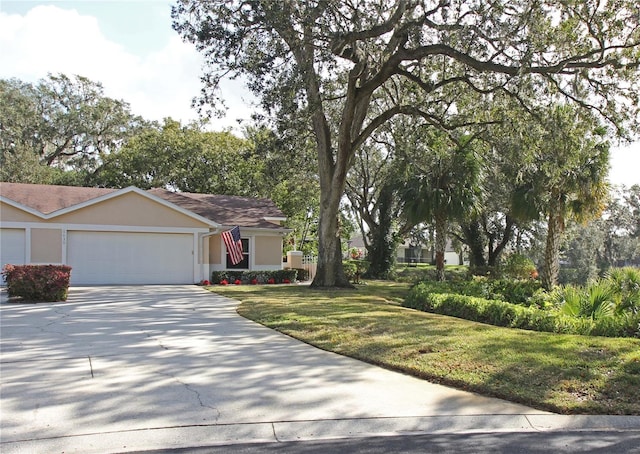 view of front of home featuring a front yard and a garage