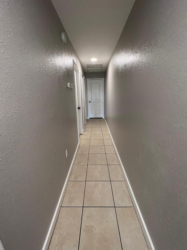 hallway featuring light tile patterned flooring