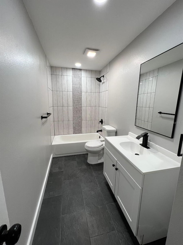 full bathroom with toilet, vanity, and tiled shower / bath