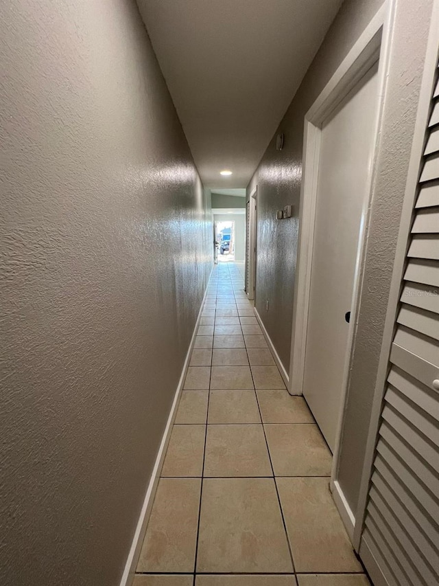 corridor with light tile patterned floors