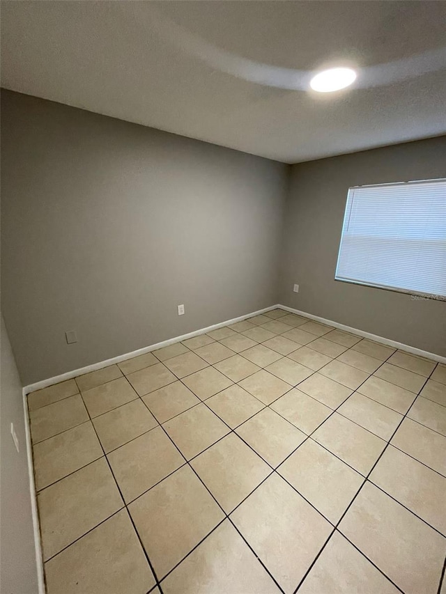 spare room with light tile patterned floors