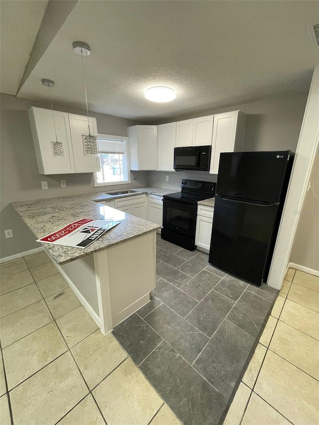 kitchen with kitchen peninsula, pendant lighting, white cabinets, and black appliances