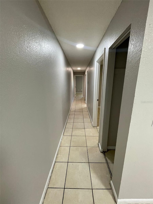 corridor featuring light tile patterned flooring