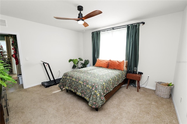 carpeted bedroom with ceiling fan and multiple windows