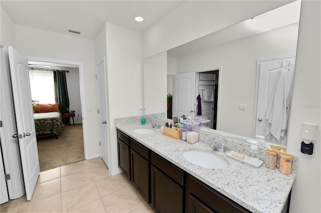 bathroom featuring tile patterned flooring and vanity