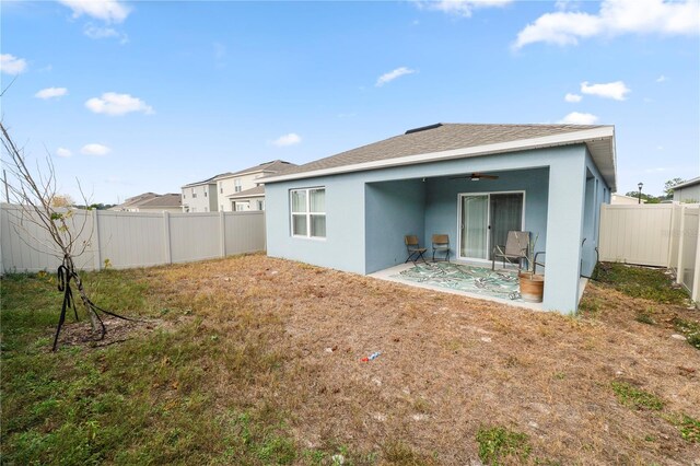 back of property featuring a patio and ceiling fan