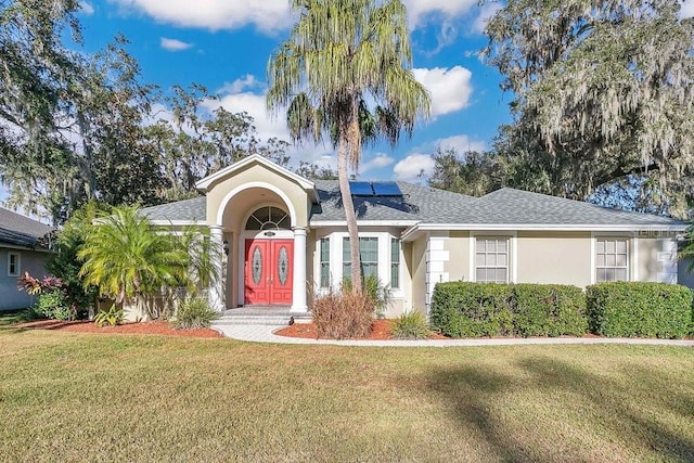 6818 Hayter Dr, Lakeland, FL 33813 - ranch-style house with solar panels and a front yard