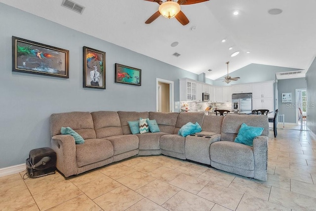 living room with ceiling fan and vaulted ceiling