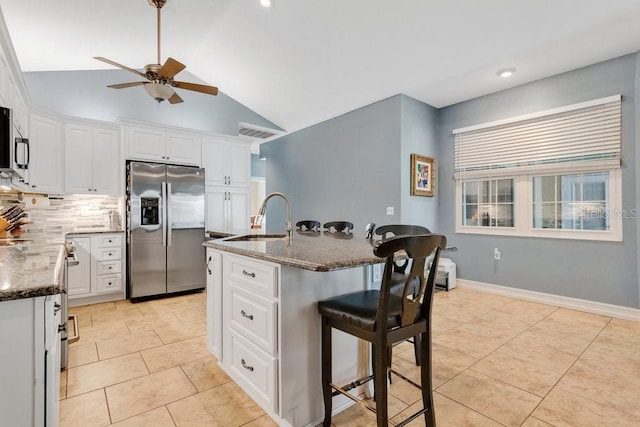 kitchen with white cabinets, an island with sink, and stainless steel refrigerator with ice dispenser