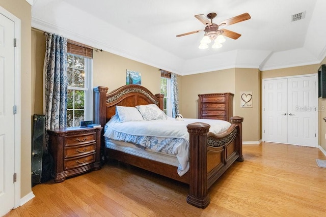 bedroom with ceiling fan, light wood-type flooring, and multiple windows