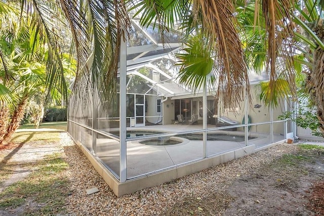 exterior space with a lanai and a patio