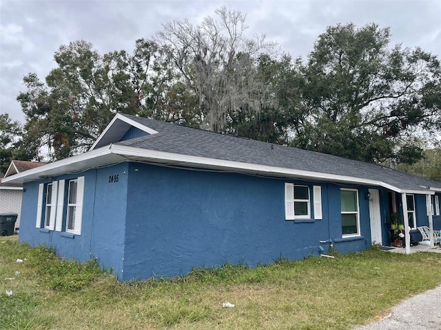 view of side of home with a lawn