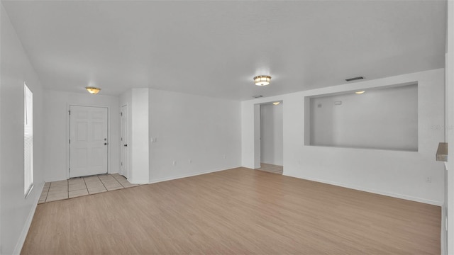 unfurnished living room with light hardwood / wood-style flooring