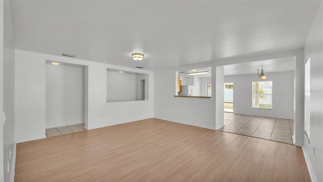 unfurnished living room with light wood-type flooring