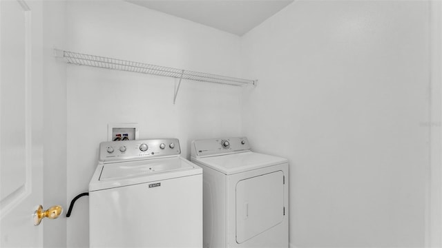 laundry room with washing machine and clothes dryer