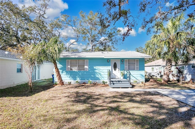 ranch-style home with a front yard and fence