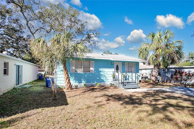 single story home with a front lawn and fence