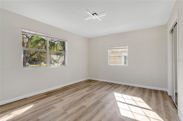 unfurnished bedroom with a closet and light hardwood / wood-style flooring