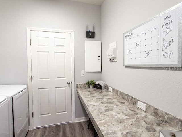 laundry room with washer and dryer and dark wood-type flooring