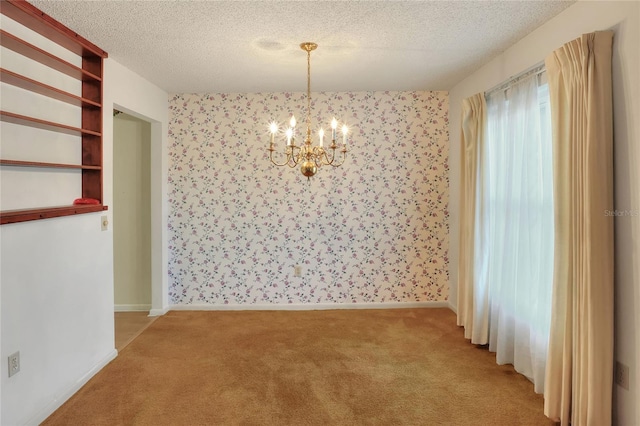 unfurnished dining area with a textured ceiling, light carpet, and a chandelier