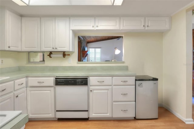 kitchen featuring white dishwasher, white cabinetry, fridge, and light hardwood / wood-style flooring