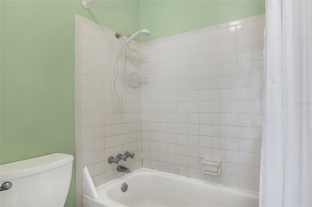 bathroom with toilet and shower / bath combo with shower curtain