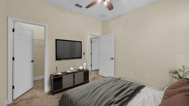 bedroom featuring a walk in closet and ceiling fan