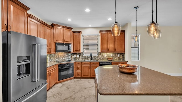 kitchen featuring sink, a center island, pendant lighting, decorative backsplash, and black appliances