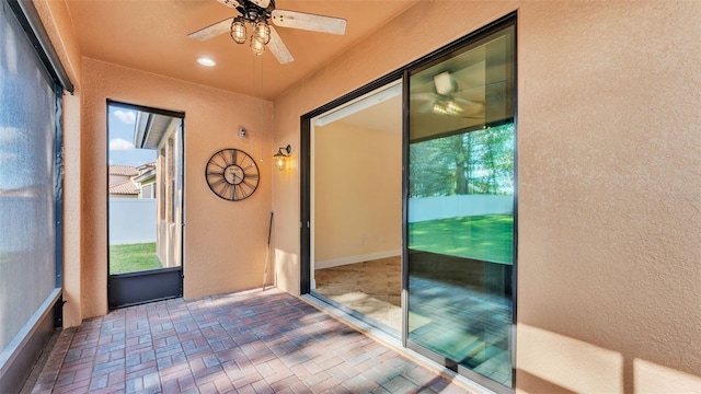 doorway with ceiling fan