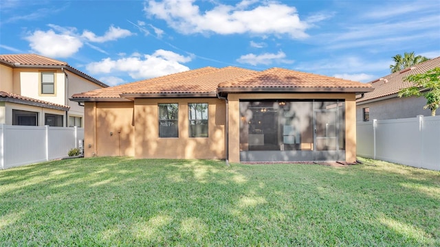 rear view of house with a lawn